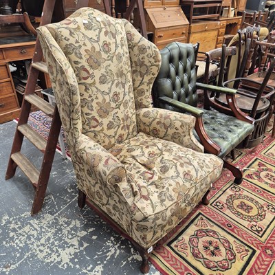 Lot 203 - A wing back armchair.
