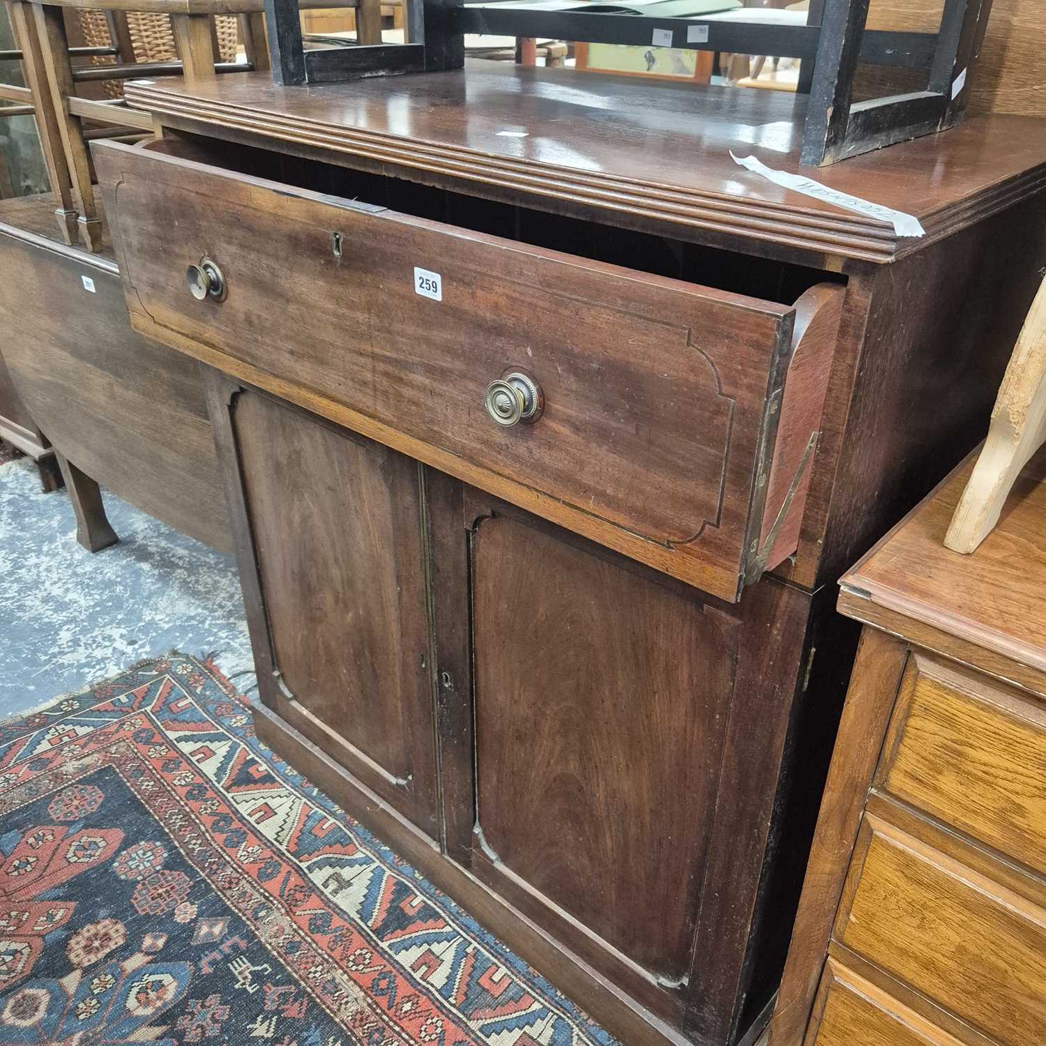 Lot 259 - An early 19th century mahogany secretaire side...