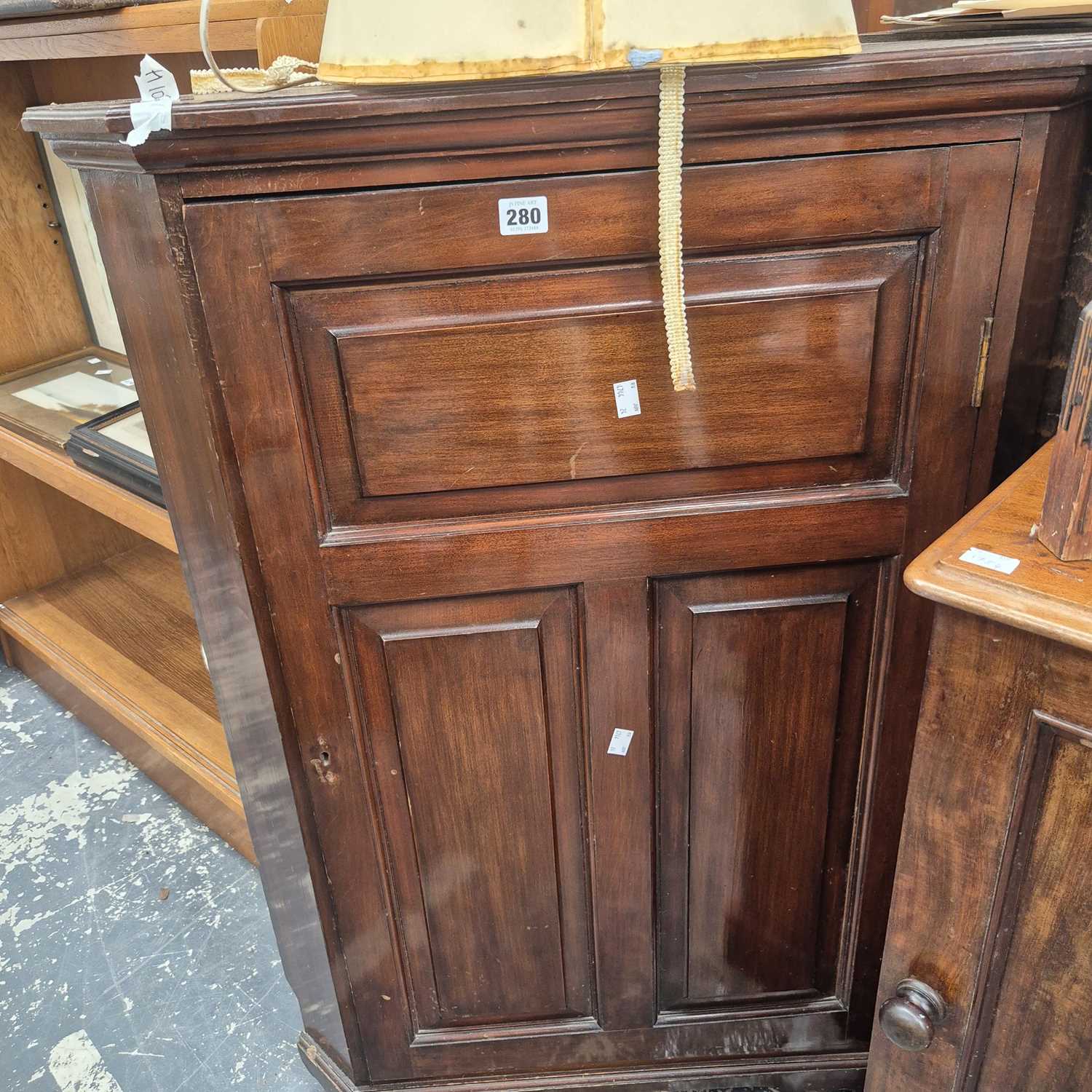 Lot 280 - A mahogany floor-standing corner cabinet.