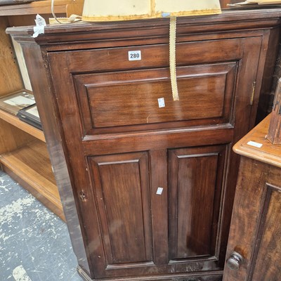 Lot 280 - A mahogany floor-standing corner cabinet.