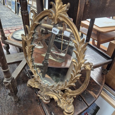 Lot 294 - A small gilt swing mirror.