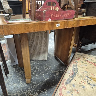 Lot 305 - An art deco style walnut extending dining table