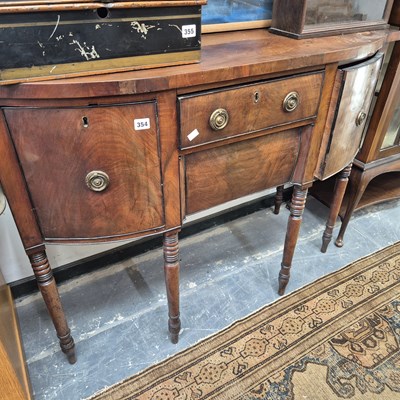 Lot 354 - A Georgian mahogany bow front side board