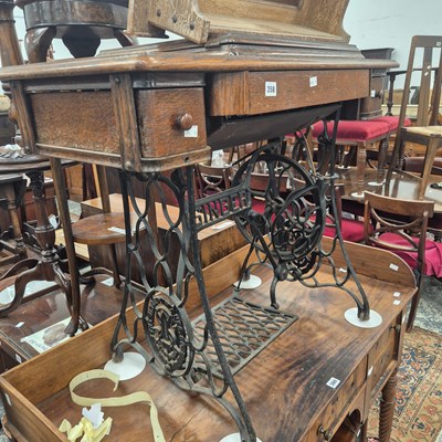 Lot 358 - A sewing machine on treadle base