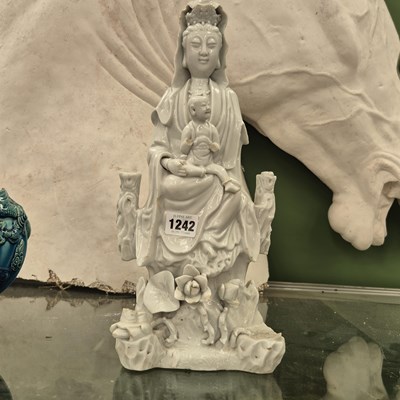 Lot 1242 - A Chinese blanc de Chine figure of Guanyin...