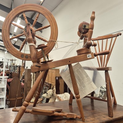 Lot 411 - A spinning wheel and spinners chair