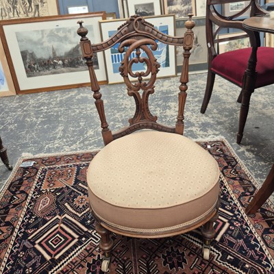 Lot 424 - A Victorian nursing chair on brass castors.