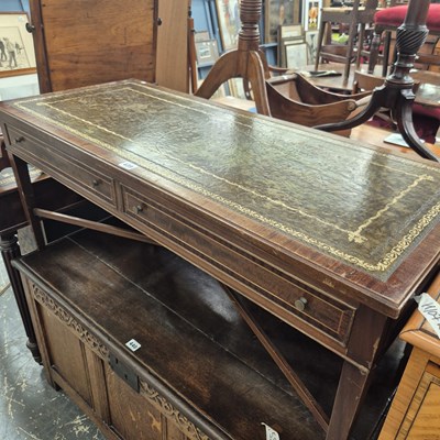 Lot 439 - A leather inset coffee table.