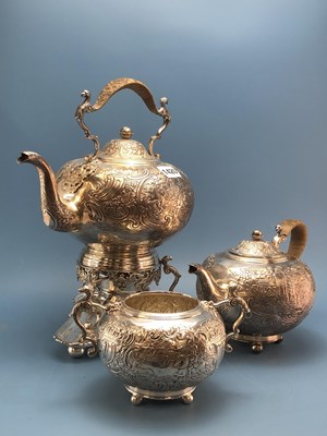 Lot 1420 - A white metal three piece tea service cast and...