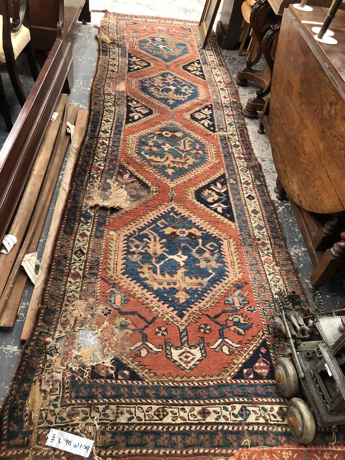 Lot 1641 - An antique Persian tribal runner, 390 x 109cms...