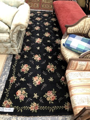 Lot 1647 - A machine made floral design rug, 292 x 189cms
