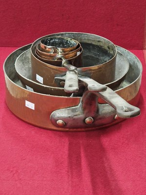Lot 1462 - A nest of three copper saucepans together with...