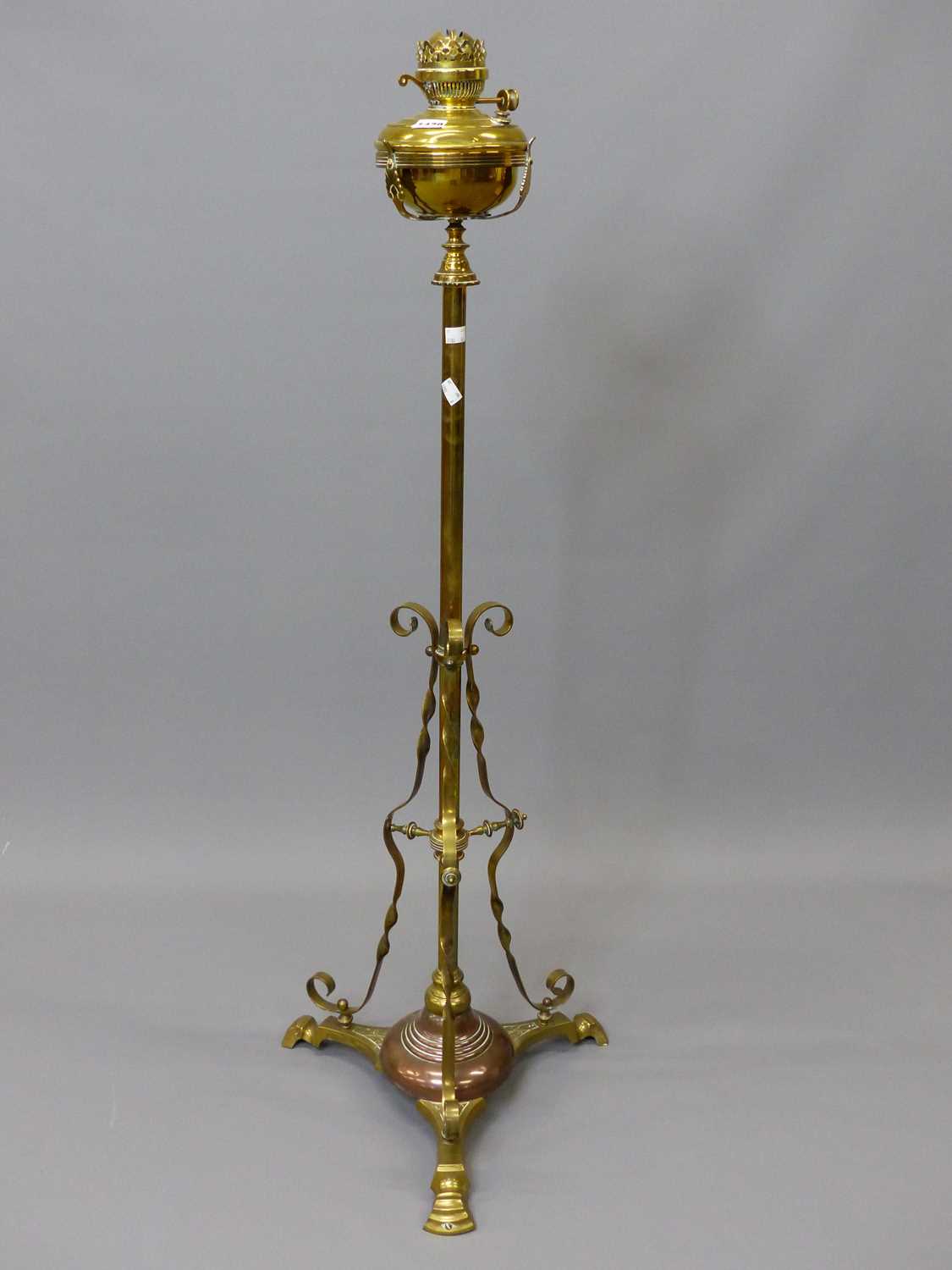 Lot 1479 - A brass floor standing oil lamp converted to...