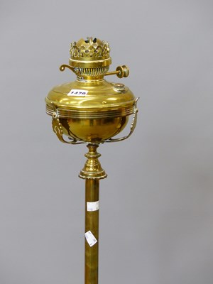 Lot 1479 - A brass floor standing oil lamp converted to...