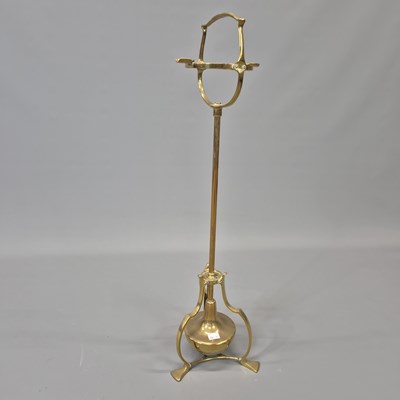 Lot 1534 - A brass floor standing ashtray stand, the...