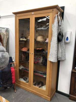 Lot 460 - An oak cabinet with glazed doors and glass...