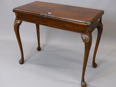 Lot 1549 - A 19th century mahogany swivel top games table...
