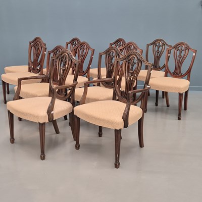 Lot 1565 - A set of twelve mahogany shield back chairs to...