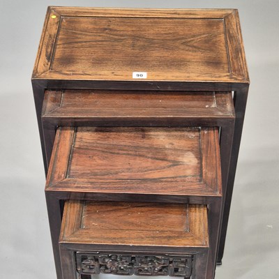 Lot 90 - A nest of four Chinese carved hardwood tables...