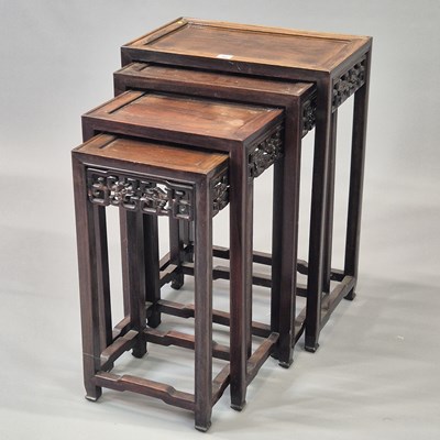 Lot 90 - A nest of four Chinese carved hardwood tables...