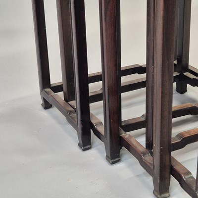 Lot 90 - A nest of four Chinese carved hardwood tables...