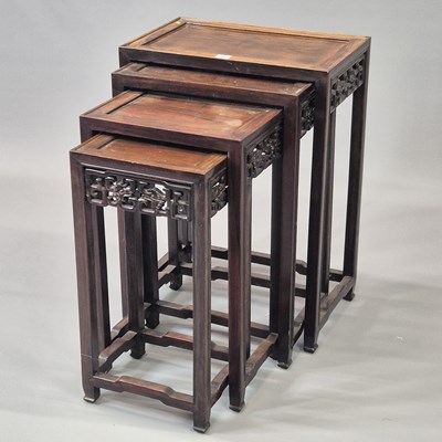 Lot 90 - A nest of four Chinese carved hardwood tables...