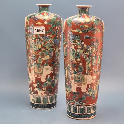 Lot 1567 - A pair of Japanese red ground ring handled...