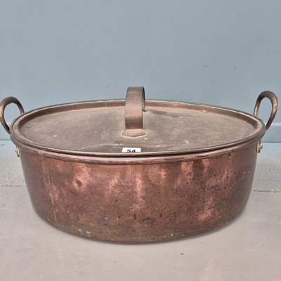Lot 54 - An antique large copper oval fish kettle with...