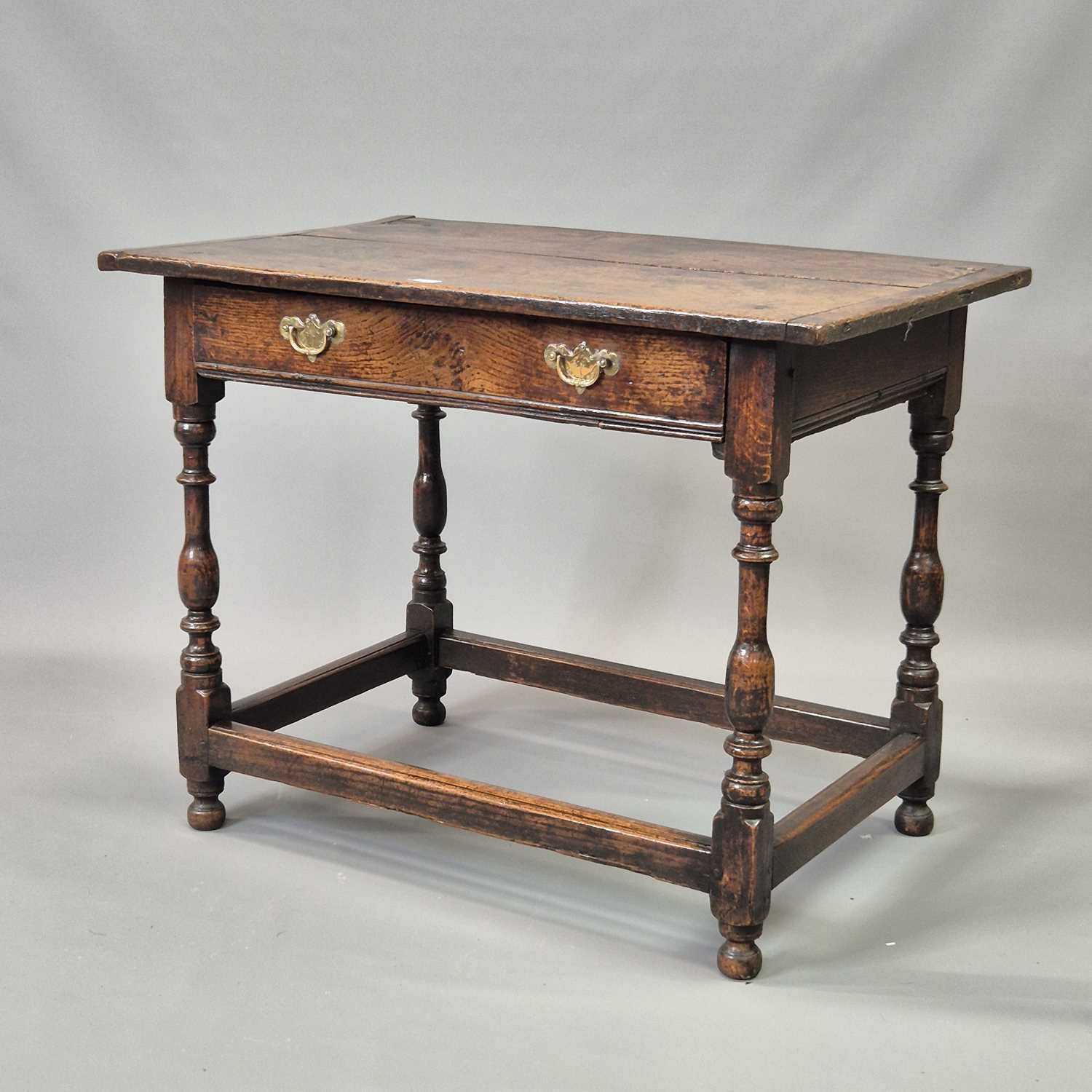 Lot 1612 - An 18th century oak side table with a drawer...