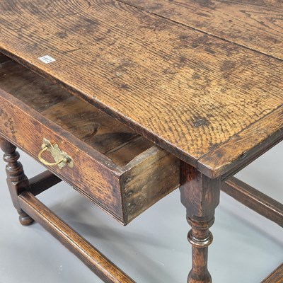 Lot 1612 - An 18th century oak side table with a drawer...