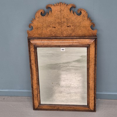 Lot 797 - A rectangular mirror in a burr walnut cushion...