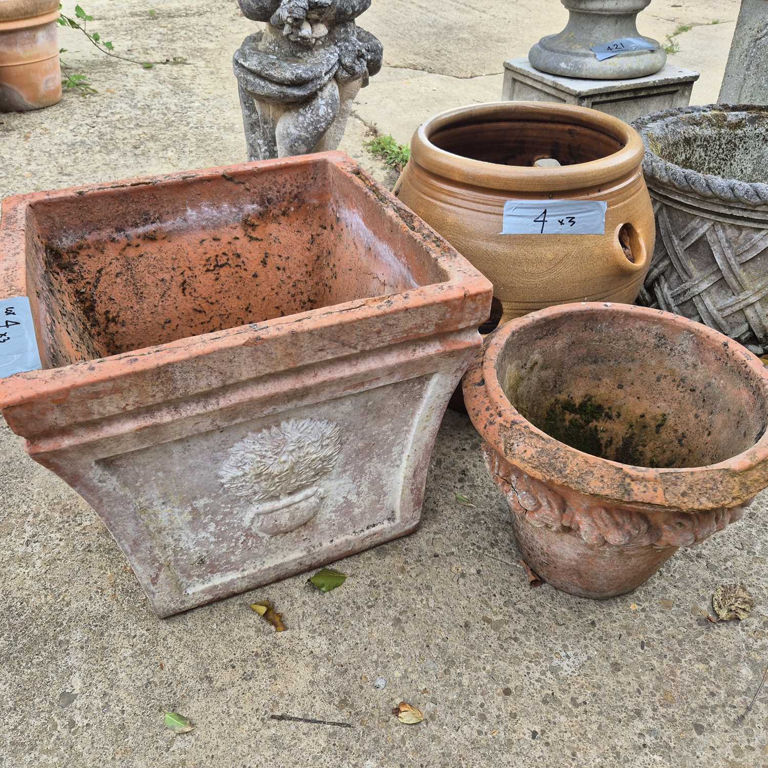 Lot 4 - Three old and weathered terracotta garden pots,...