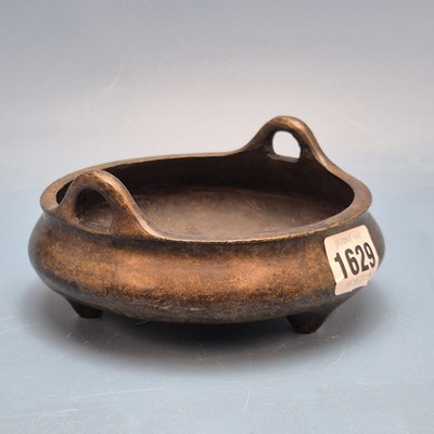 Lot 1629 - A Chinese bronze two handled censer supported...