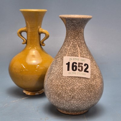 Lot 1652 - A Chinese mustard yellow glazed two handled...