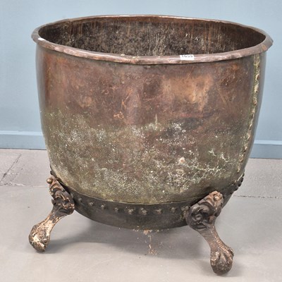 Lot 1659 - A copper copper raised on four ball and claw...
