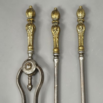 Lot 1668 - A set of three fire irons with beaded foliate...