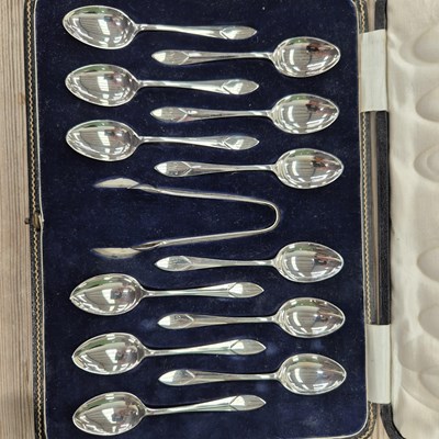 Lot 1688 - A cased set of twelve silver tea spoons with...