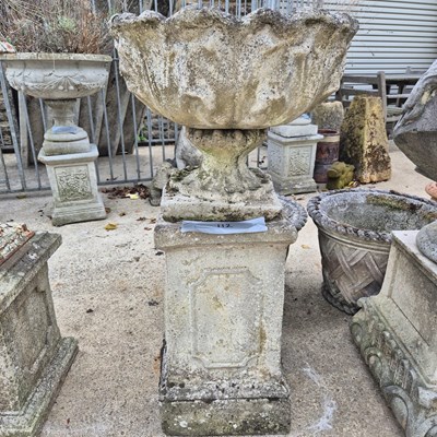 Lot 112 - A weathered composite stone petal form garden...