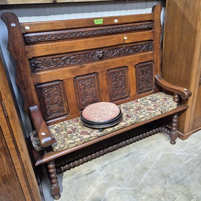 Lot 34 - A 19th-century oak highback hall settle with...