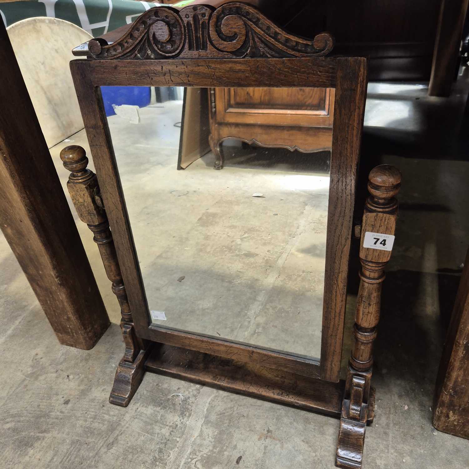 Lot 74 - An oak swing mirror.