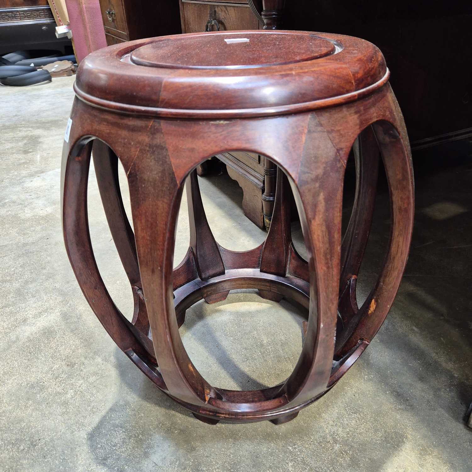 Lot 81 - An oriental hardwood urn stand.