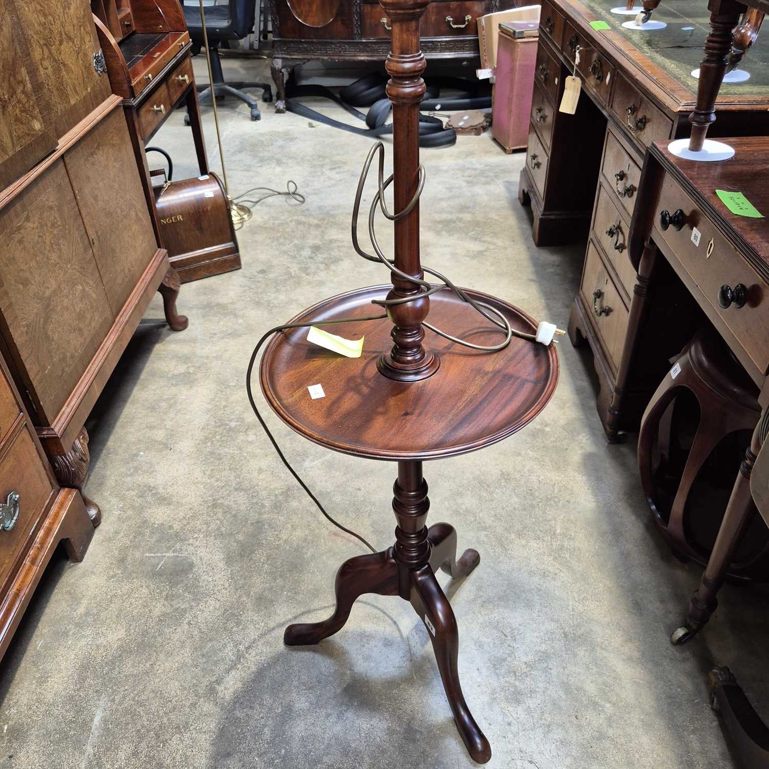 Lot 83 - A mahogany table lamp with a wine table tier.