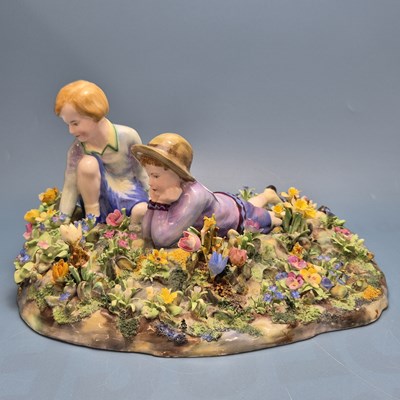 Lot 1701 - A Crown Staffordshire porcelain group of a boy...