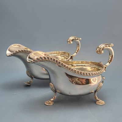 Lot 1702 - A pair of silver tripod sauce boats by the...