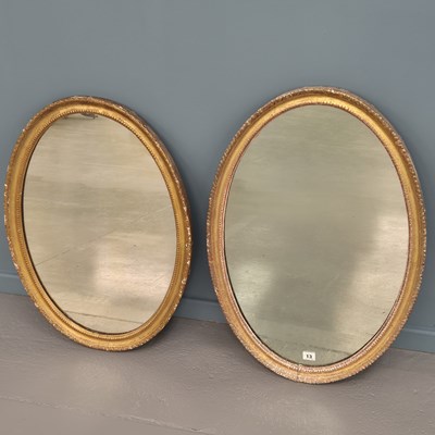 Lot 13 - Two similar Georgian carved giltwood oval...