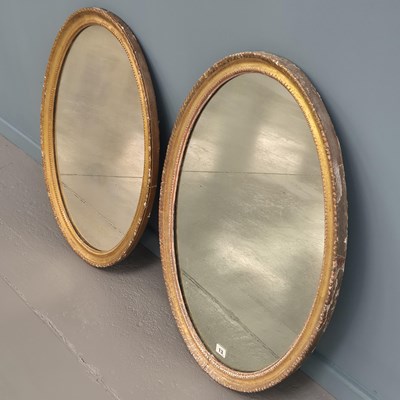 Lot 13 - Two similar Georgian carved giltwood oval...
