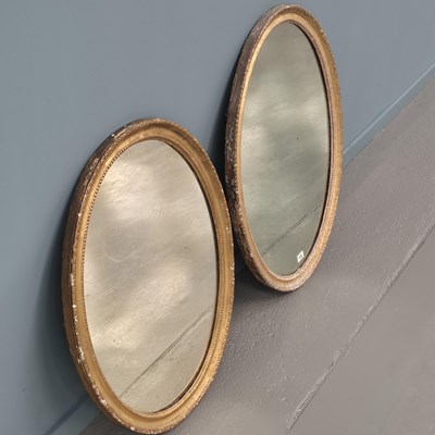 Lot 13 - Two similar Georgian carved giltwood oval...