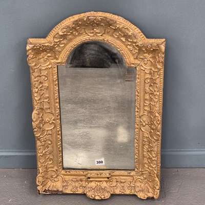 Lot 300 - An early French carved giltwood mirror with an...