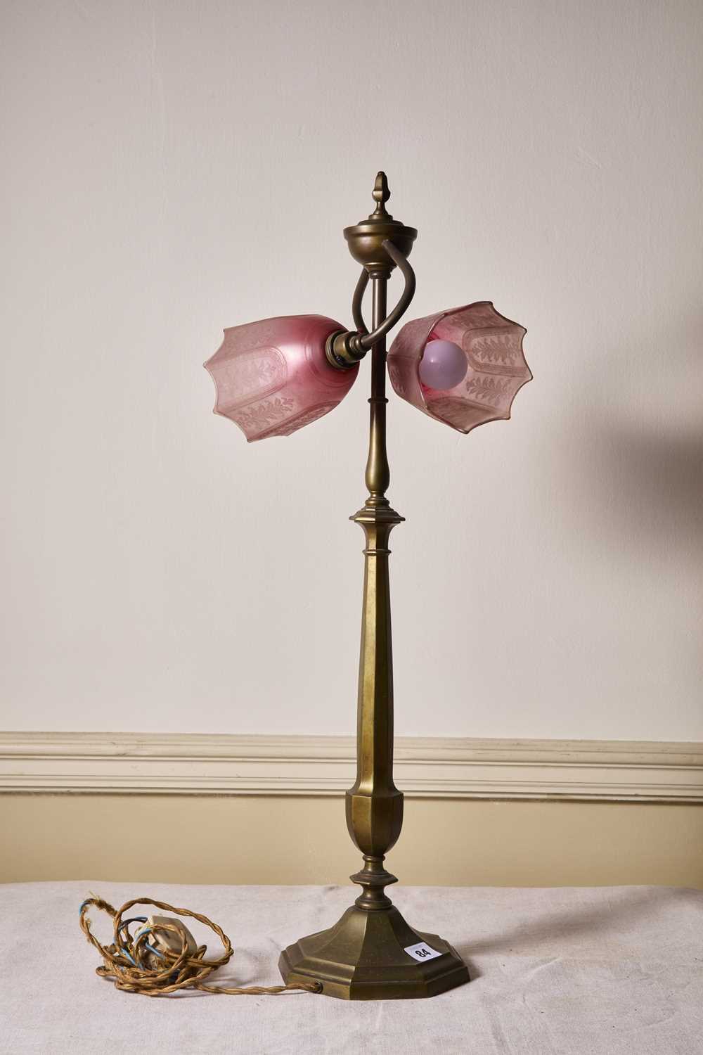 Lot 84 - An early 20th Century brass two light table...