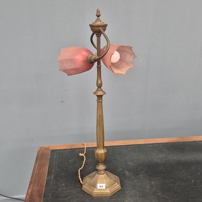 Lot 84 - An early 20th Century brass two light table...